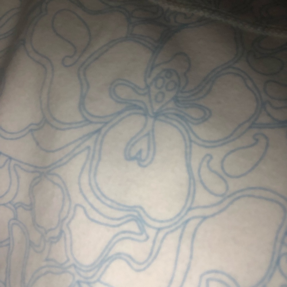 A Reebok XS women’s jacket with a flower pattern.